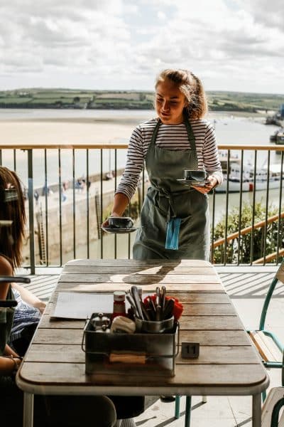 Girl serving coffee at Greens of Padstow