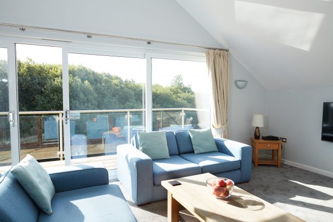 Blue sofas in living room at KingFisher Lodge Cornwall