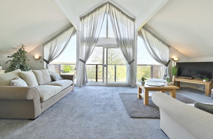 Apex living room with large windows.