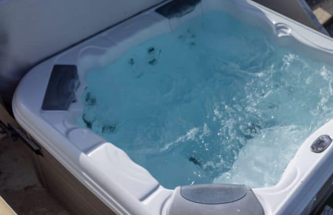 Bubbling hot tub at waterside holiday lodge